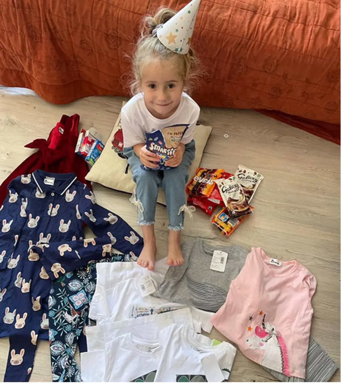 Kid receiving sweets and clothes